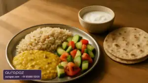 A balanced Indian meal of brown rice, dal, salad, curd and chapatis on a wooden table